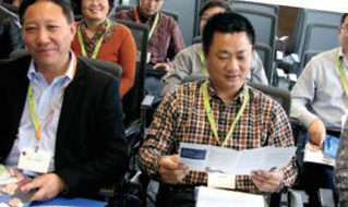 Photo de membres d’une délégation de Chine. Ils lisent des brochures et des dépliants pour se renseigner sur le mandat de l’Ordre.