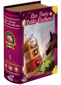 Illustration de la couverture du jeu Les trois petits cochons où un loup souffle sur la maison des trois petits cochons. 