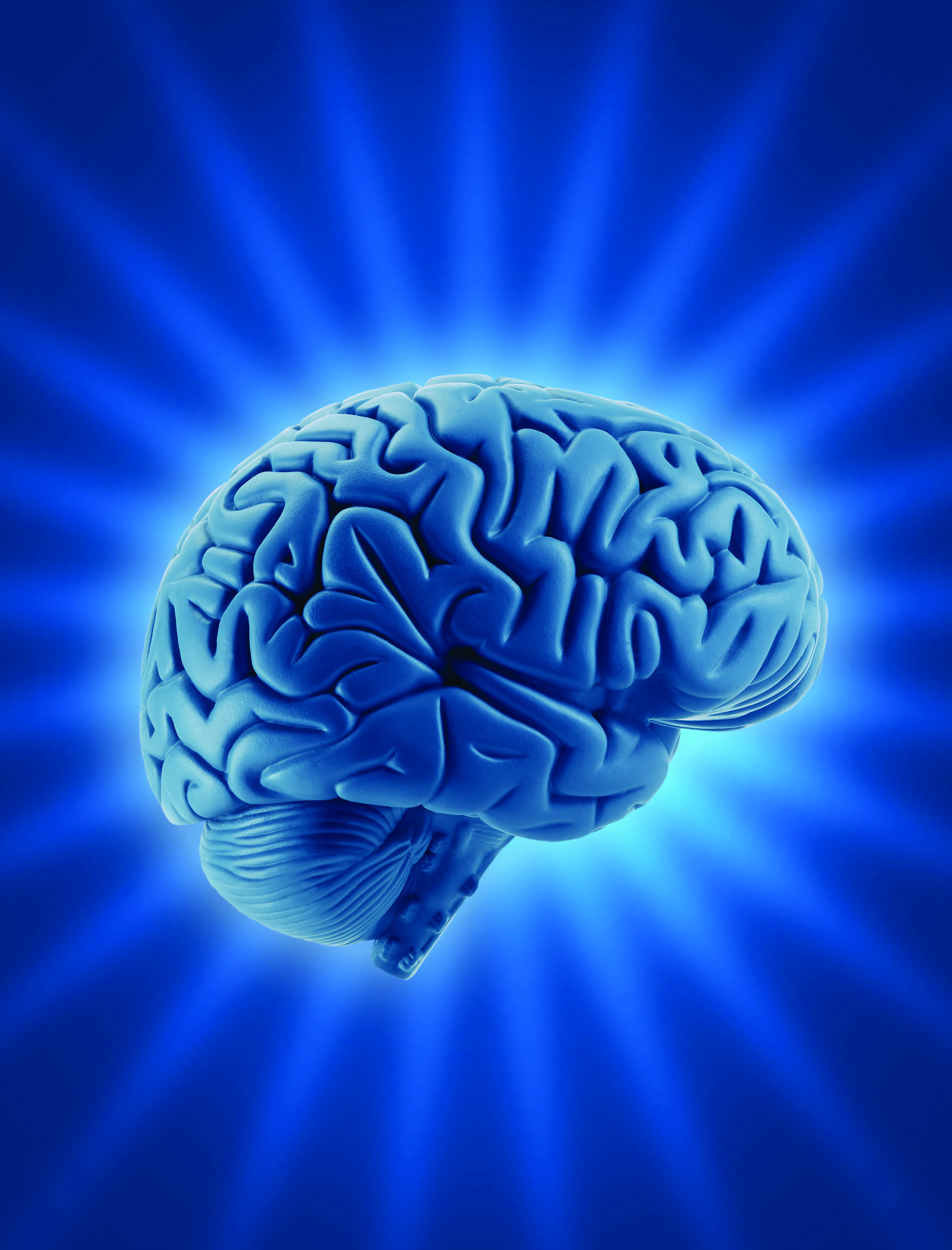 Image d'un cerveau humain sur fond de rayons lumineux.