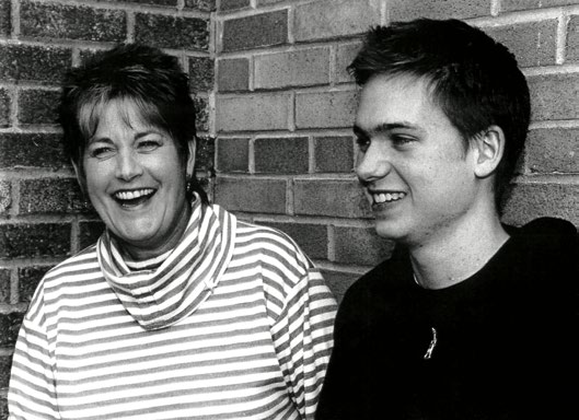 A photo of Deborah Barton-Moore and Patrick J. Adams.