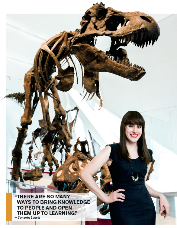 A photo of Samantha Laforêt standing in front of a Tyrannosaurus Rex fossil display.