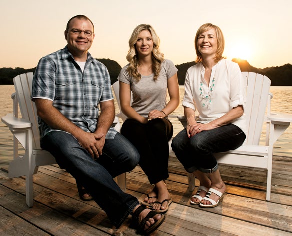 A photo of guidance counsellor Nico Byl and principal Kimberly Williams sitting with former Huntsville High School student, and recent Olympic gold medallist, Dara Howell.