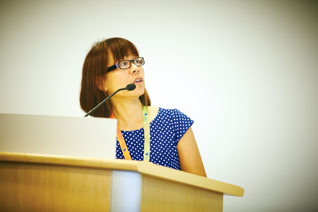 A photo of Dora Nipp from the Ontario Human Rights Commission speaking at a podium.