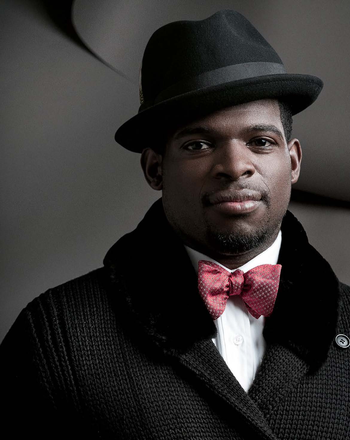 Photo of  P.K. Subban. P.K is wearing a dapper bowtie and Derbie hat