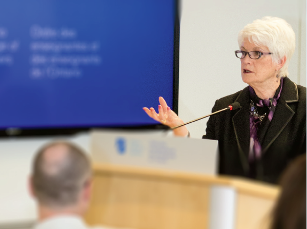 A photo of Ontario Minister of Education Liz Sandals standing at a podium and speaking.