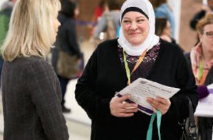 A photo of College staff greeting a parent at the Ottawa-Carleton DSB parent conference.