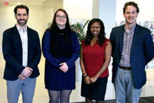 A photo of College staff standing with representatives from Education First in Boston.