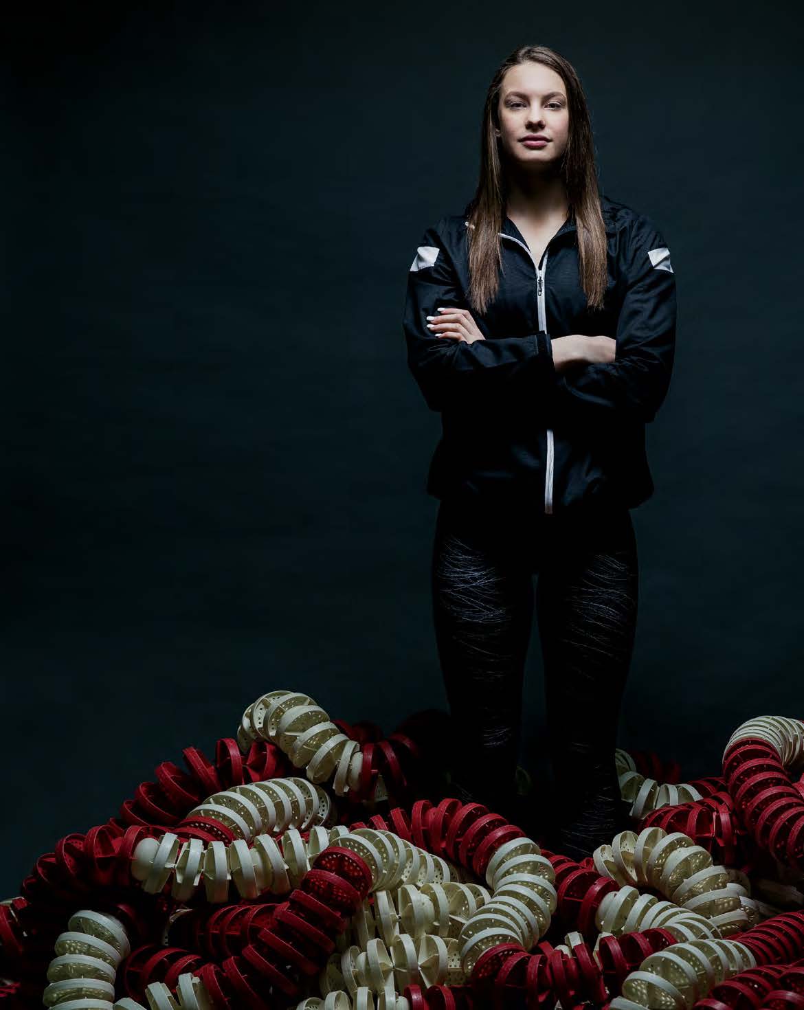 Photo of Olympic swimmer Penny Oleksiak standing confidently with arms crossed.