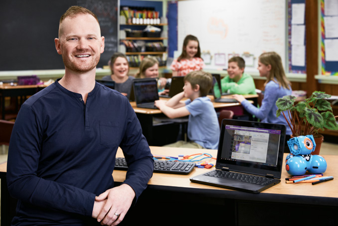 Photo of Ryan Tindale, Ontario Certified Teacher in a classroom with students.