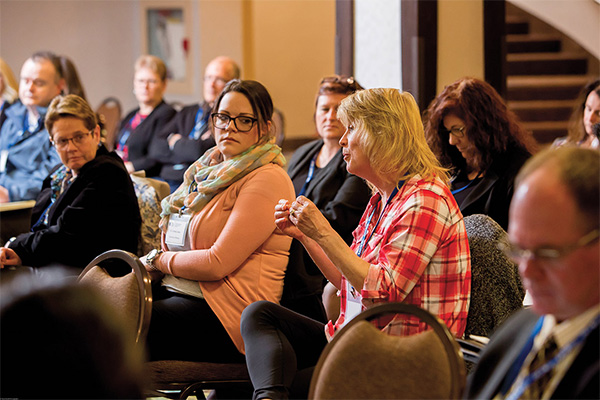 Photo of a group of people watching a presentation about 'Supporting Students' Mental Health' in Windsor.