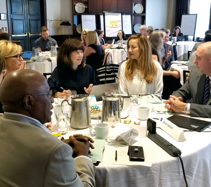Photo of College Council and staff members seated at a table.