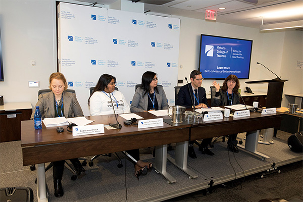 Photo of a group of people seated at a panel.