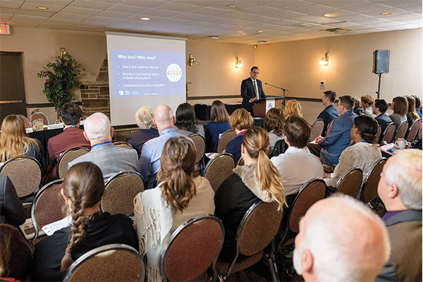 Photo of a group of people watching a presentation about 'Supporting Students' Mental Health' in Sudbury.