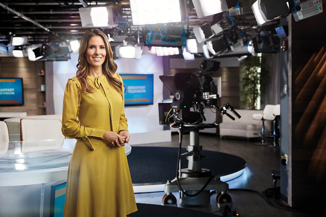 Photo of Citytv Breakfast Television co-host Dina Pugliese standing in a television news studio.