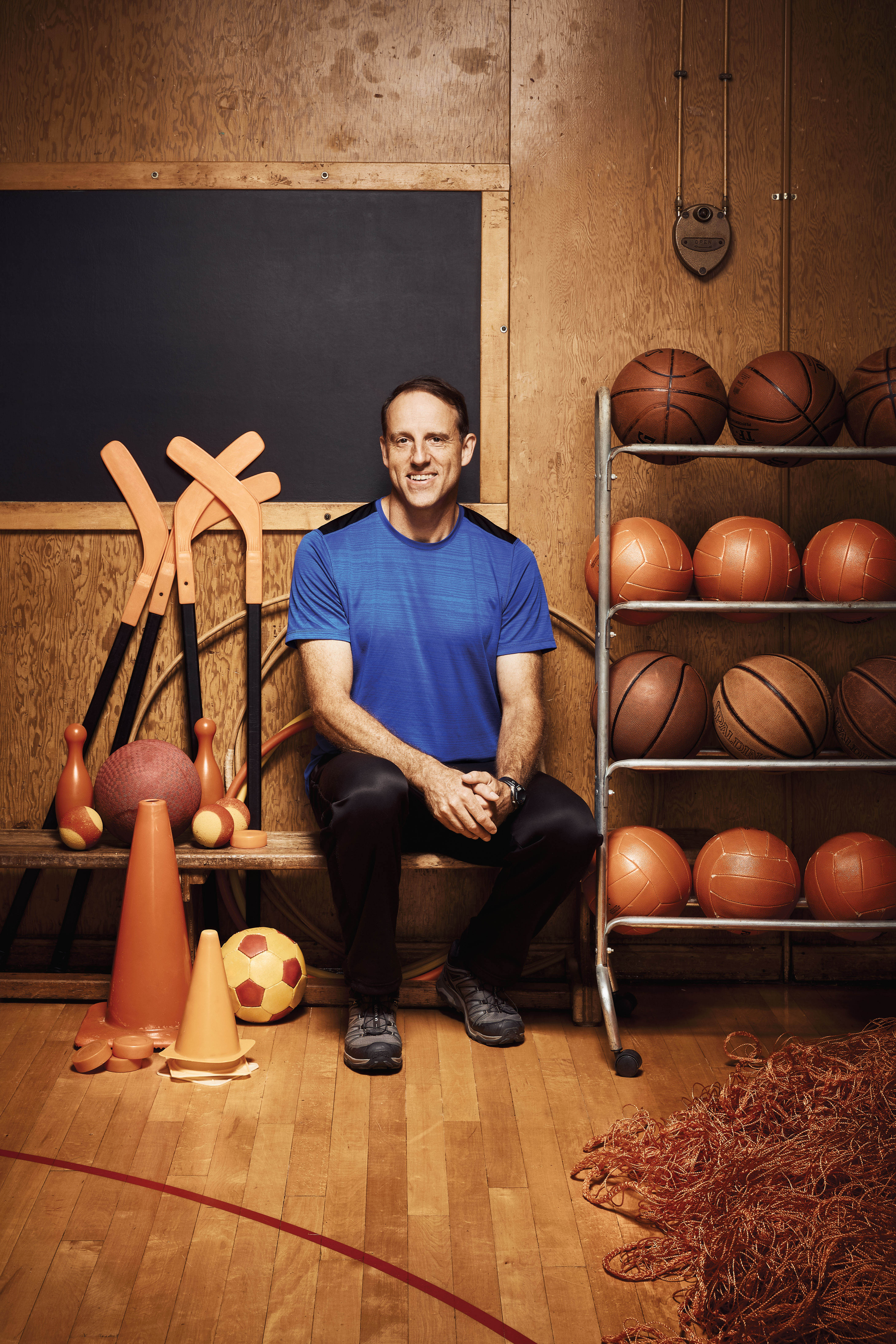 Photo of Steven Whitaker, Ontario Certified Teacher, seated in a school gymnasium.