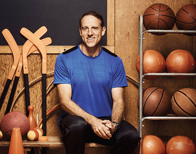 Photo of Steven Whitaker, Ontario Certified Teacher, seated in a school gymnasium.