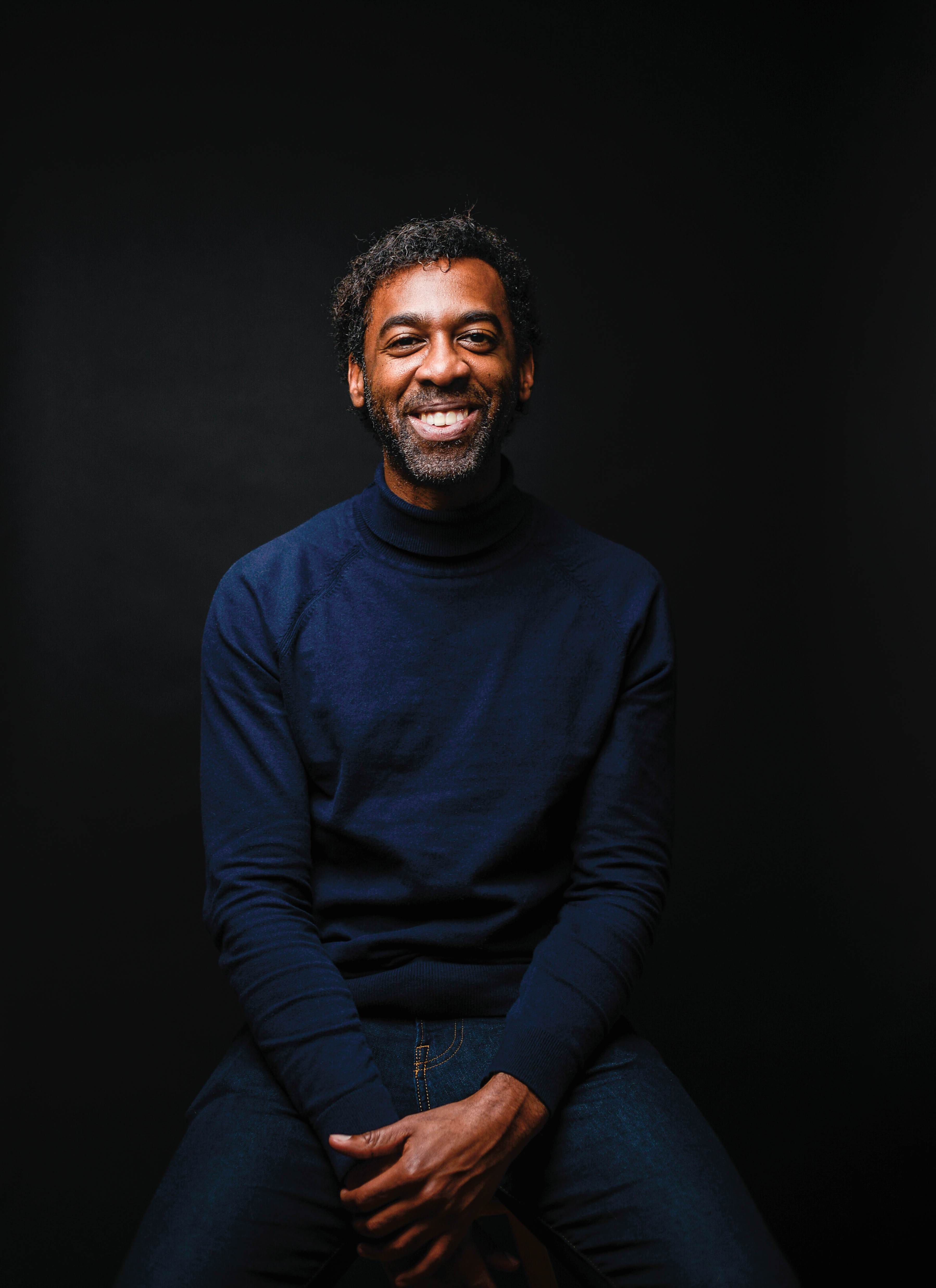 Photo of award-winning author Ian Williams, smiling.