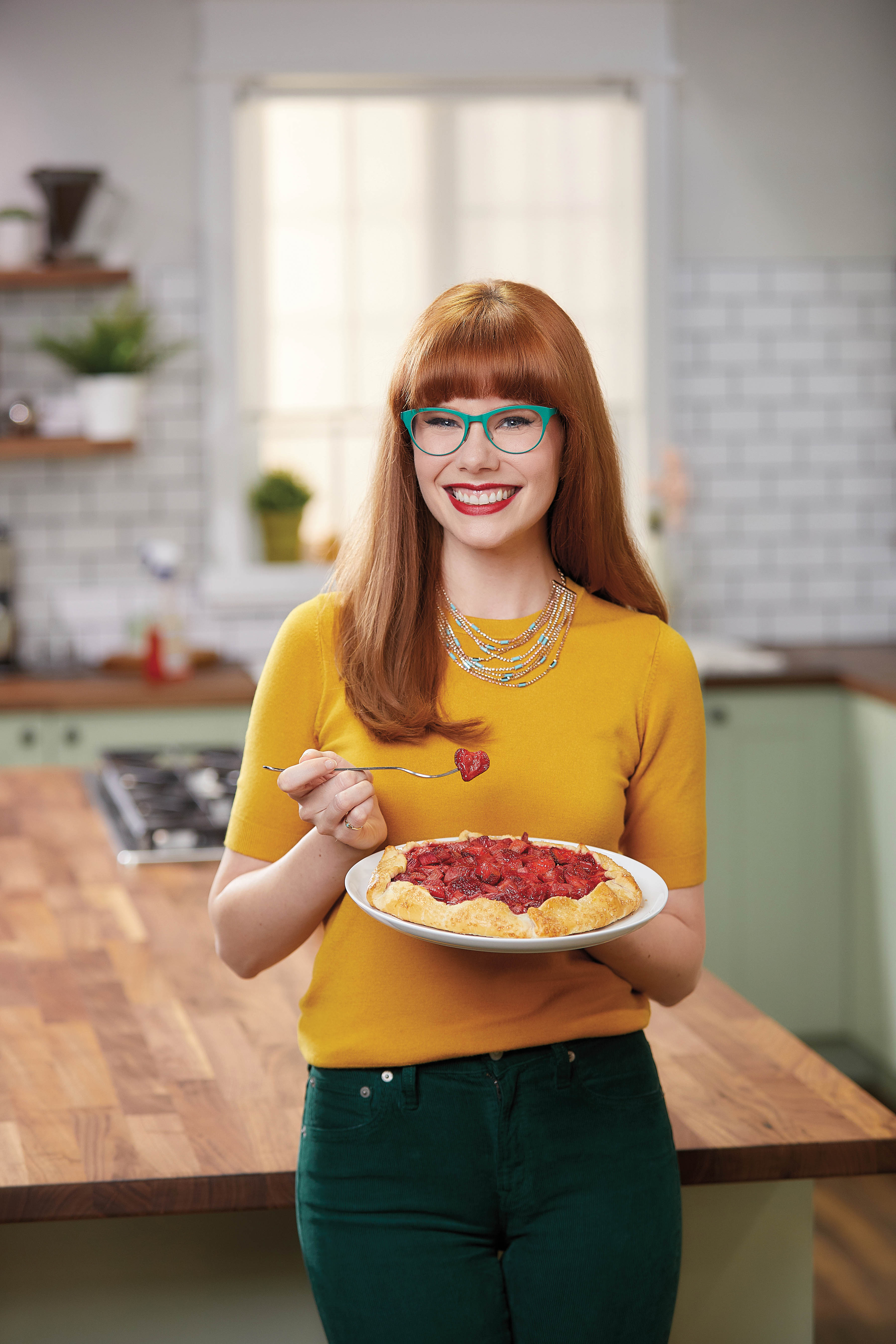 Mary Berg poses with a baked good.