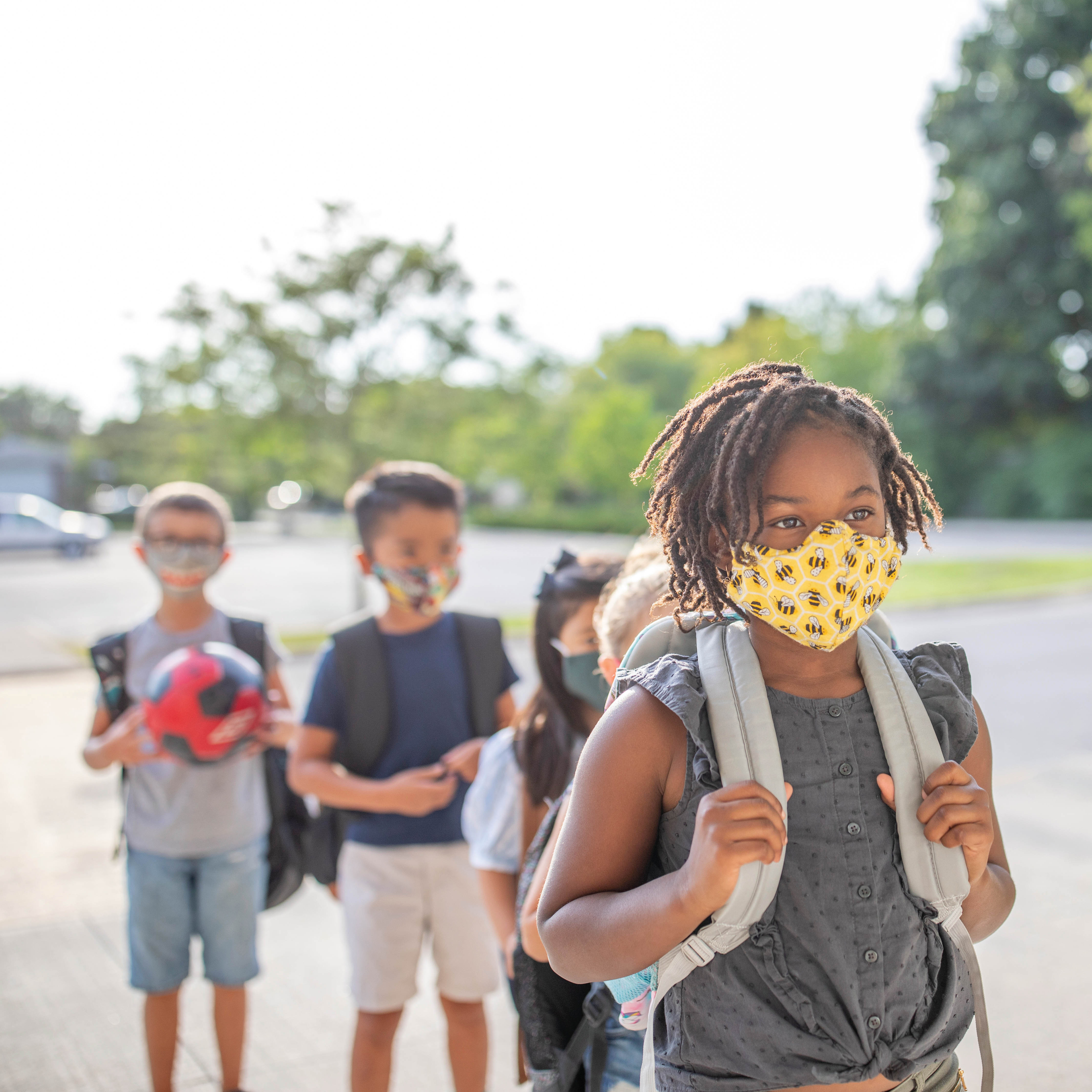 Students in line wear face masks