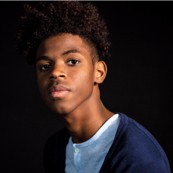 A young Black student looking directly at the camera.
